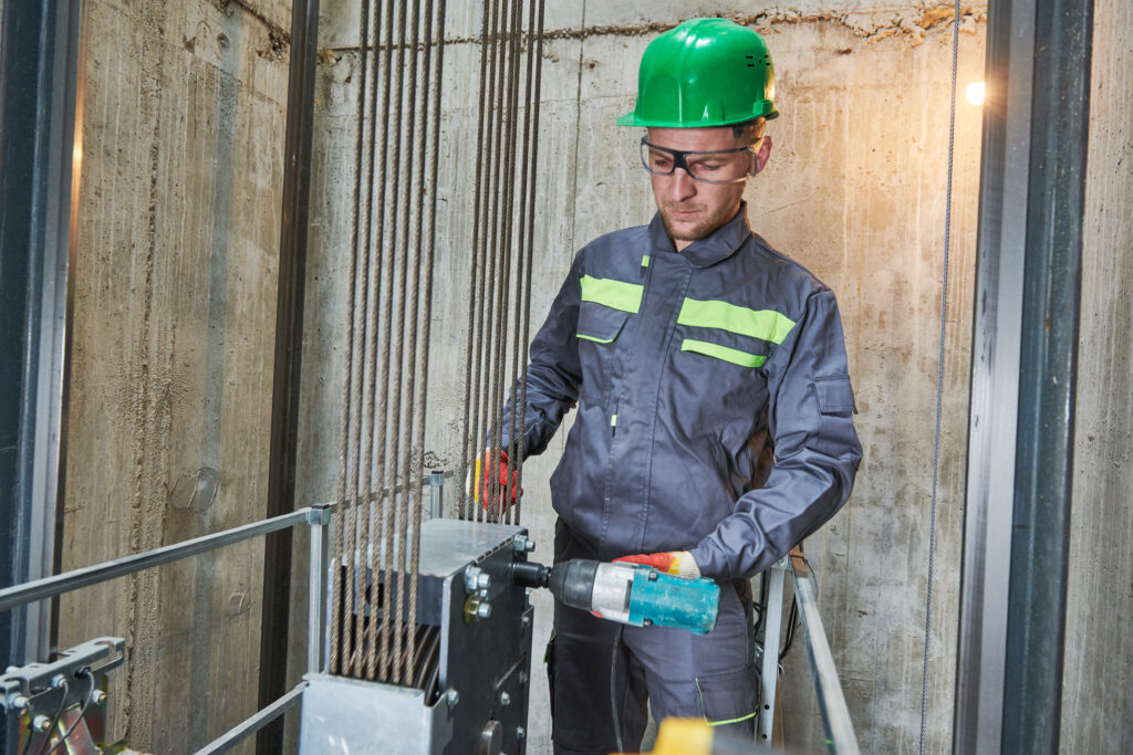 Axxiom Technician Performing Elevator Maintenance